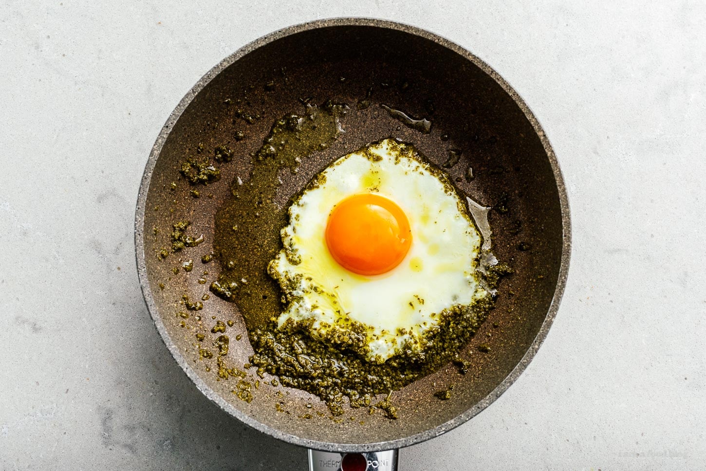 frying egg in pesto | sharefavoritefood.com